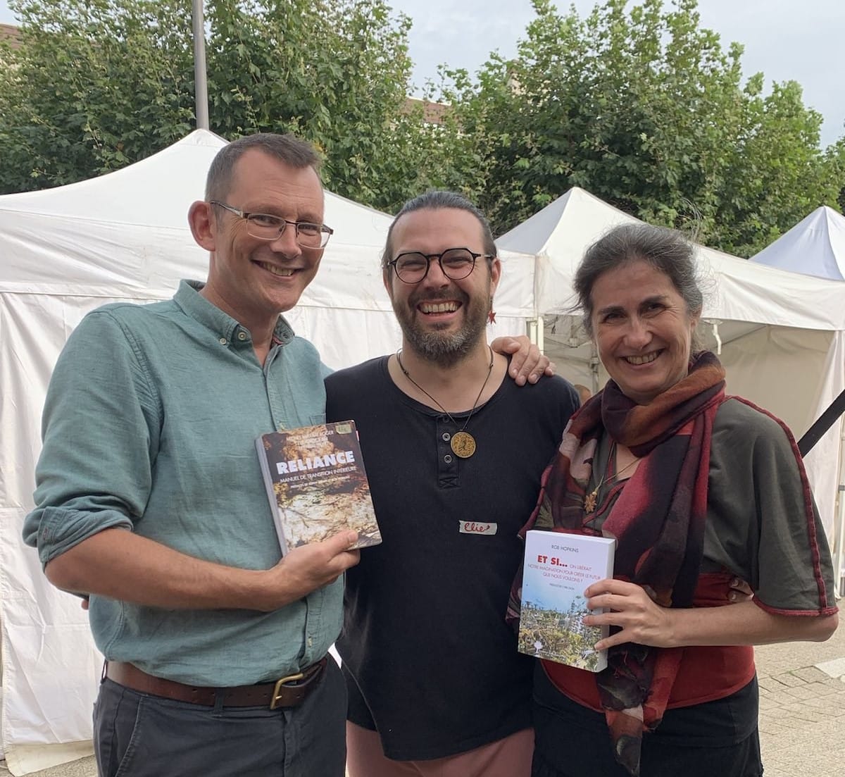 Rob Hopkins, Elie Wattelet and Tylie Grosjean exchanging their books